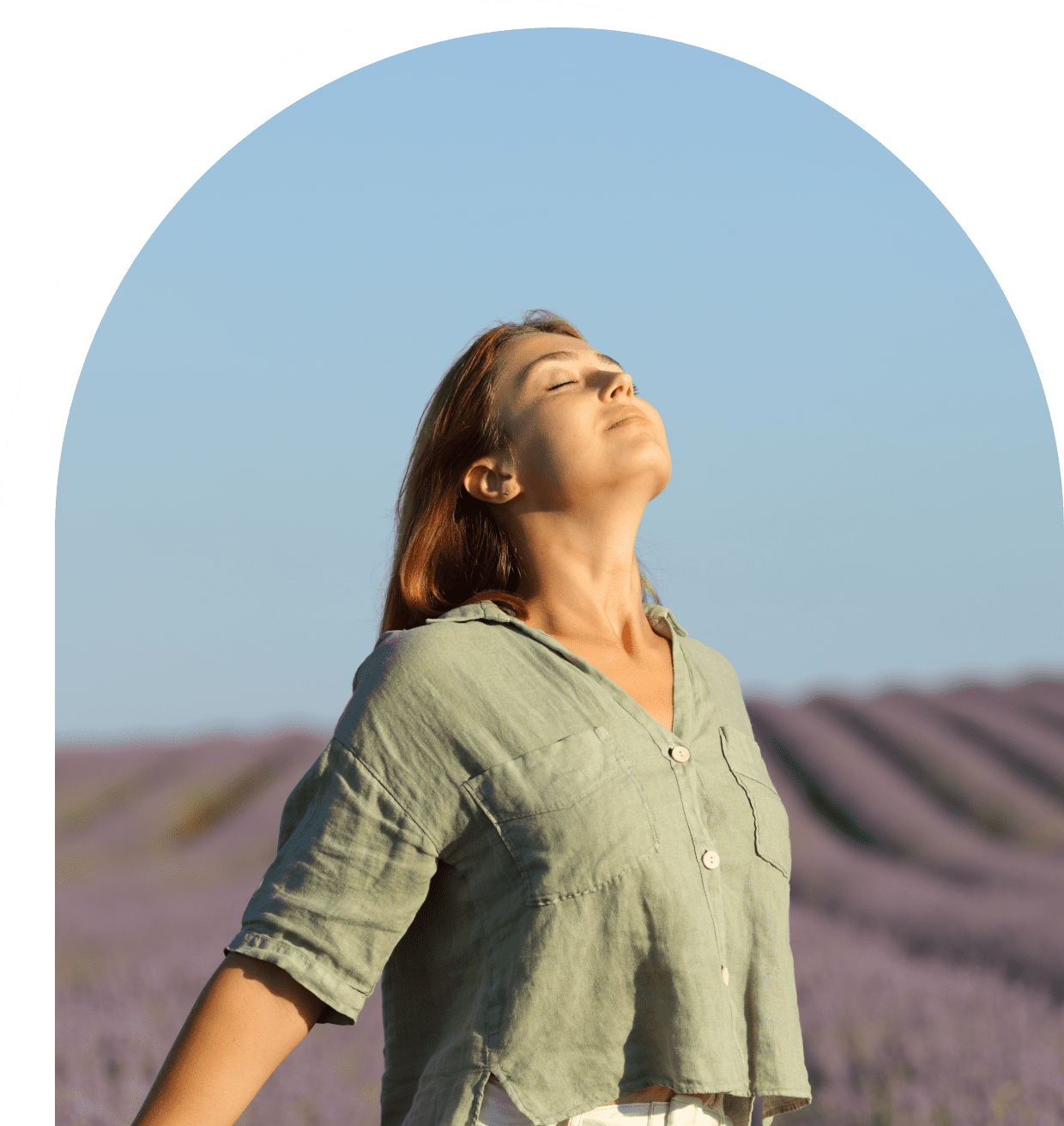 Woman enjoying fresh air in lavender field.